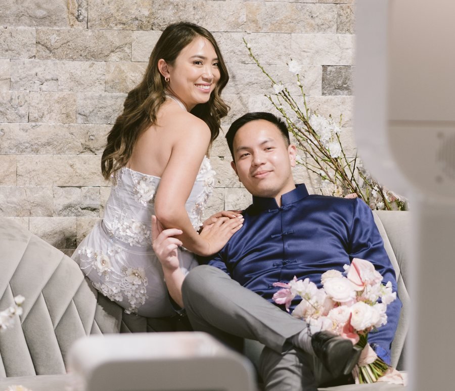 A couple posing together on the lounge sofa at the booth